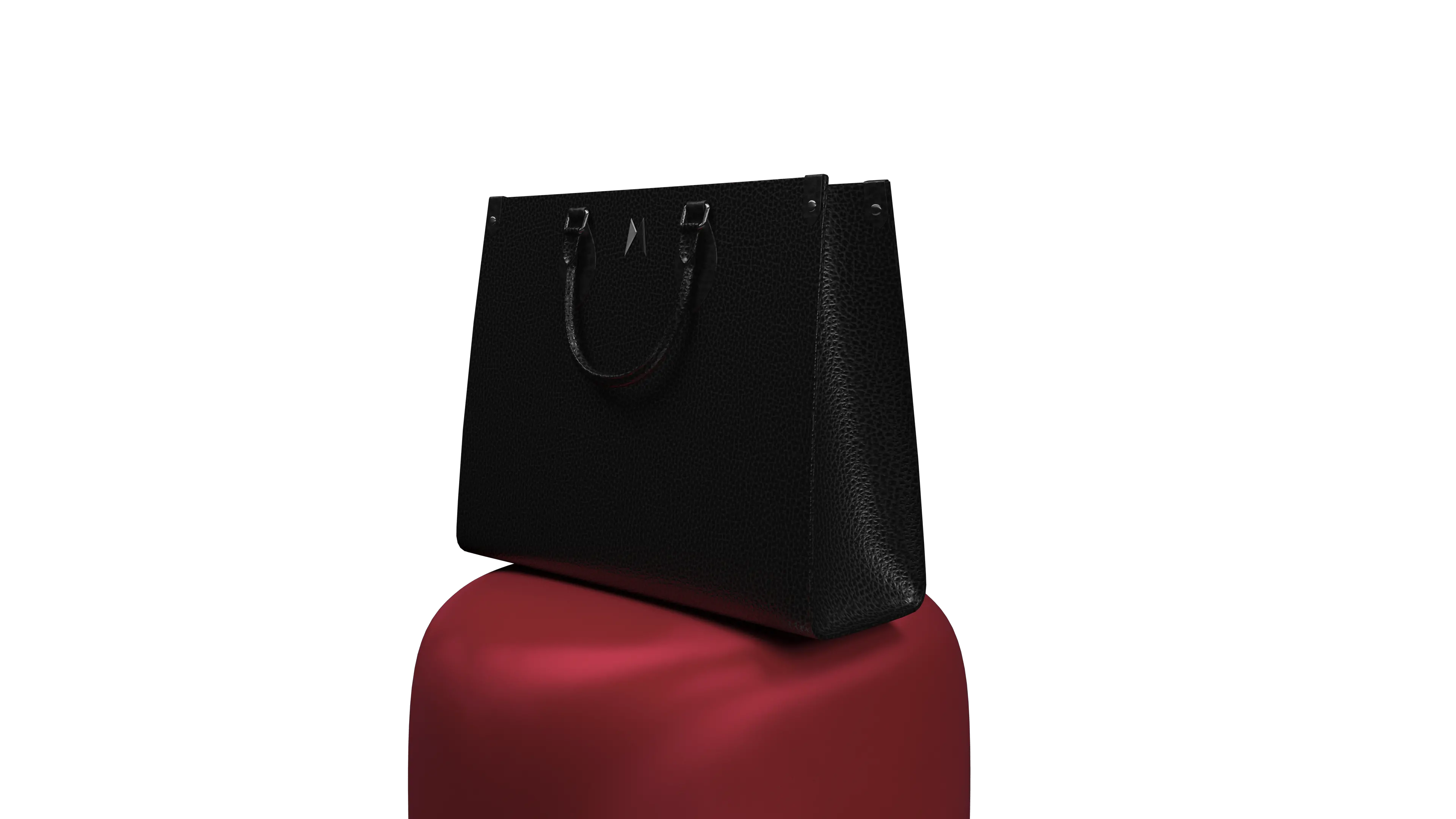 Black leather handbag sitting on a red, velvety stand